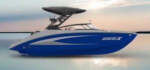 Yamaha Boats 255XD 2025 Yamaha Boats 255XD in blue on calm water at sunset.