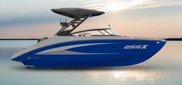 Yamaha Boats 255XD 2025 Yamaha Boats 255XD in blue on calm water at sunset.
