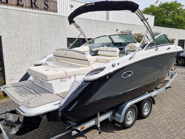 Cobalt R3 2021 Cobalt R3 boat on trailer, sleek black design, parked outdoors.