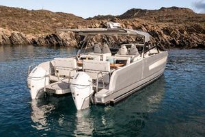 YOT 36 2025 YOT 36 boat with dual engines, anchored in a serene rocky cove.