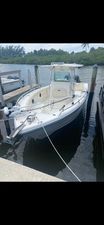 Mako 284 Center Console 2014 Mako 284 Center Console boat docked in a serene marina setting.