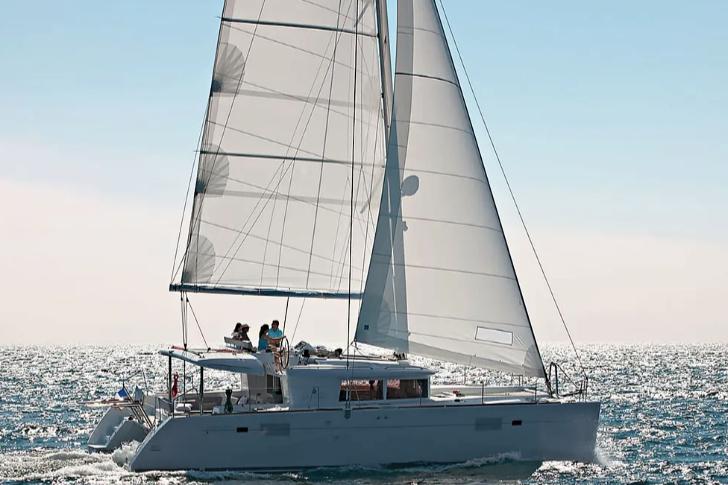 Lagoon 450F 2018 Lagoon 450F catamaran sailing on open sea with people on deck.
