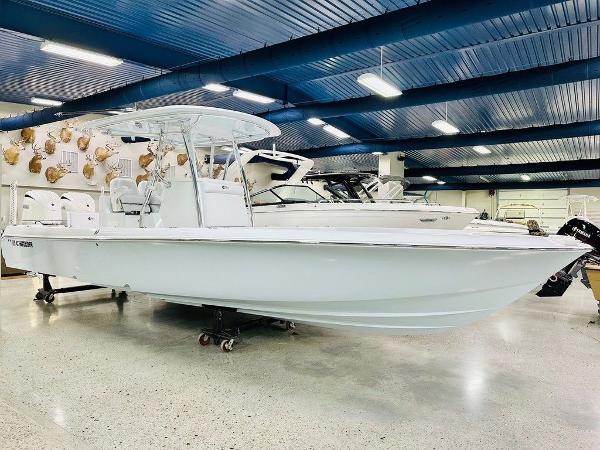 Contender 29BAY 2025 Contender 29BAY boat displayed in a showroom with blue ceiling and bright lighting.