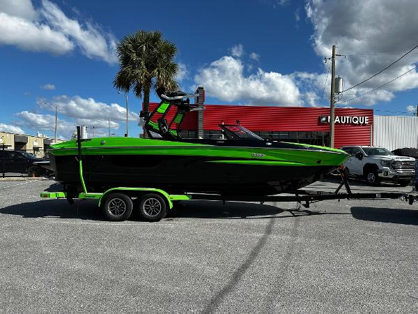 Supreme S240 2024 Supreme S240 boat in black and green on a trailer, parked outdoors.