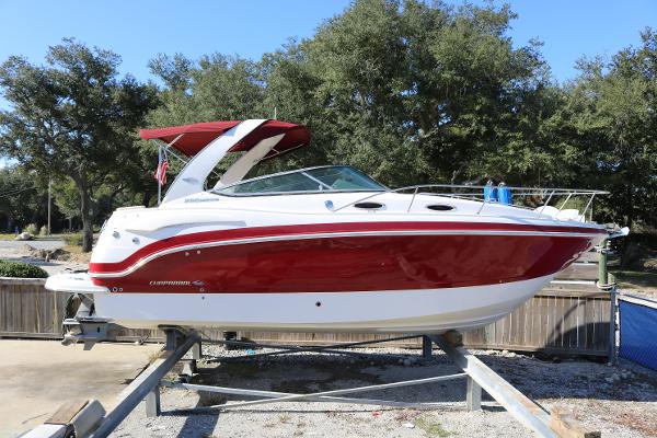 Chaparral 290 Signature 2016 Chaparral 290 Signature boat with red and white exterior on a trailer.