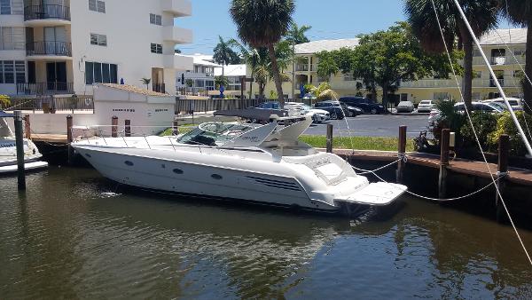 Trojan 440 Express Yacht 1999 Trojan 440 Express Yacht docked in a sunny marina setting.