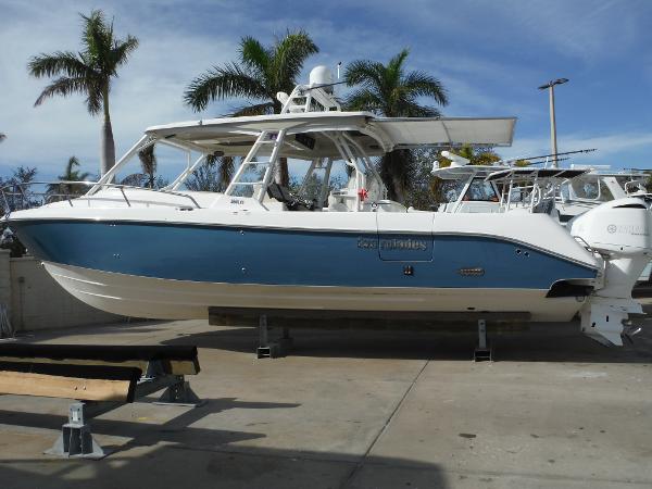 Everglades 360LXC 2017 Everglades 360LXC boat on display with palm trees in the background.