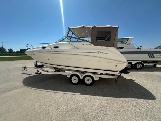 Sea Ray 240 Sundancer 1997 Sea Ray 240 Sundancer boat on trailer under clear blue sky.