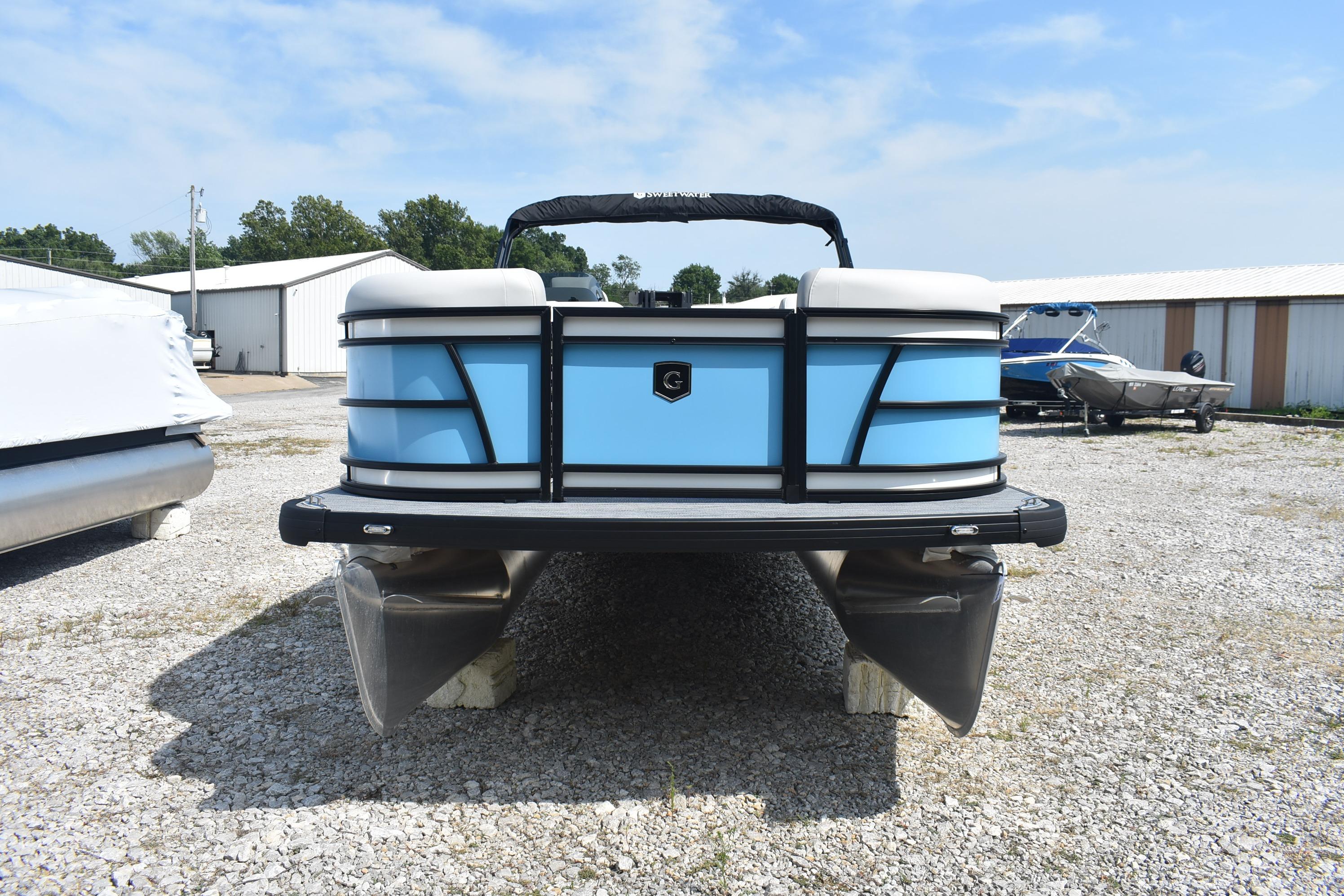 Godfrey Sweetwater 2086 C 2026 Godfrey SWEETWATER SW 2086 C pontoon boat, blue exterior, parked on gravel lot.