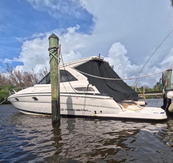 Regal 35 Sport Coupe 2015 Regal 35 Sport Coupe docked on a sunny day with a cloudy sky.