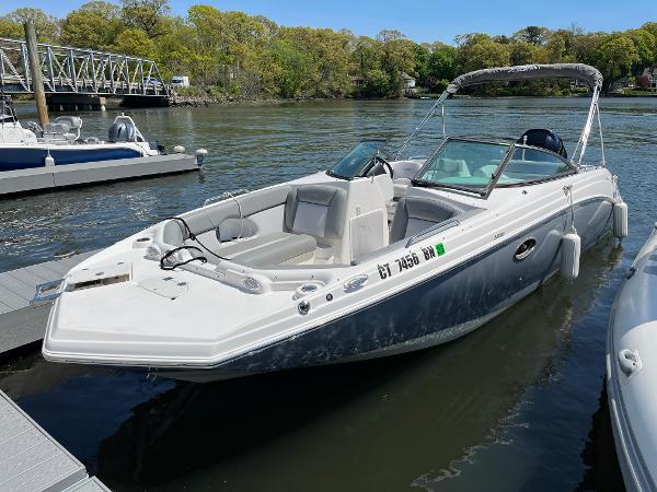 NauticStar 243 DC 2022 NauticStar 243 DC boat docked on a calm river.