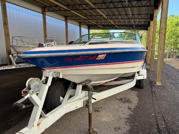 MasterCraft MARISTAR 225 VRS 1994 MasterCraft MARISTAR 225 VRS boat on trailer under a covered storage area.