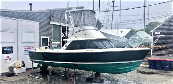 Bertram 31 Sportfish Flybridge 1986 Bertram 31 Sportfish Flybridge boat on dry dock at a marina.