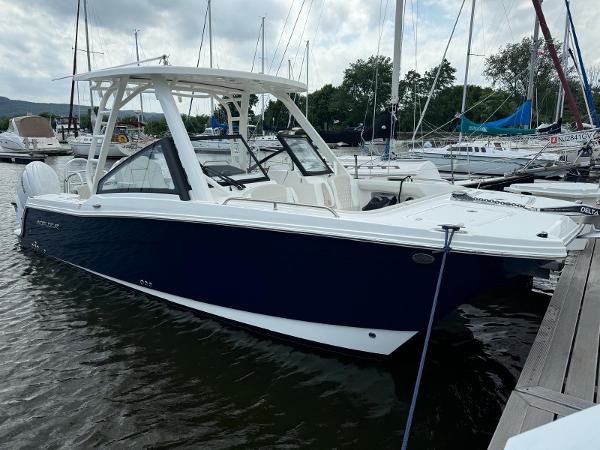 World Cat 260 DC-X 2024 World Cat 260 DC-X boat docked in marina, featuring sleek design and spacious seating.