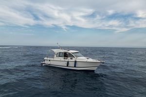 Nimbus 335 Coupe 2013 Nimbus 335 Coupe boat on open sea under cloudy sky.
