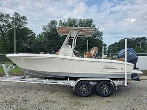 Pioneer 202 Islander 2025 Pioneer 202 Islander boat on trailer, parked outdoors, with trees and cloudy sky background.