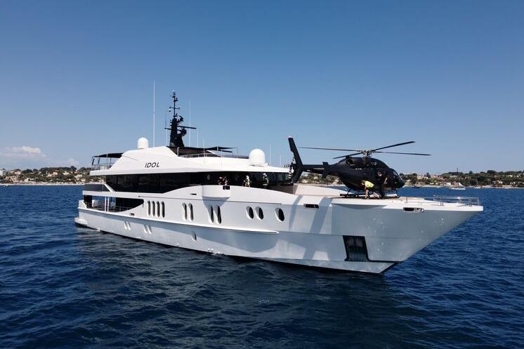Austal Displacement Luxurious 2007 Austal Displacement yacht with helicopter on deck, cruising in clear blue waters.