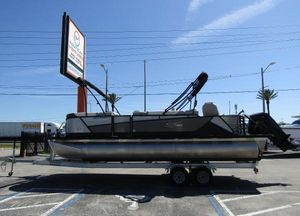 SunChaser Eclipse 8523 Fish 2023 SunChaser Eclipse 8523 Fish pontoon boat on trailer in parking lot.