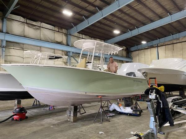Sportsman 231 Heritage 2022 Sportsman 231 Heritage boat in a warehouse, undergoing maintenance.