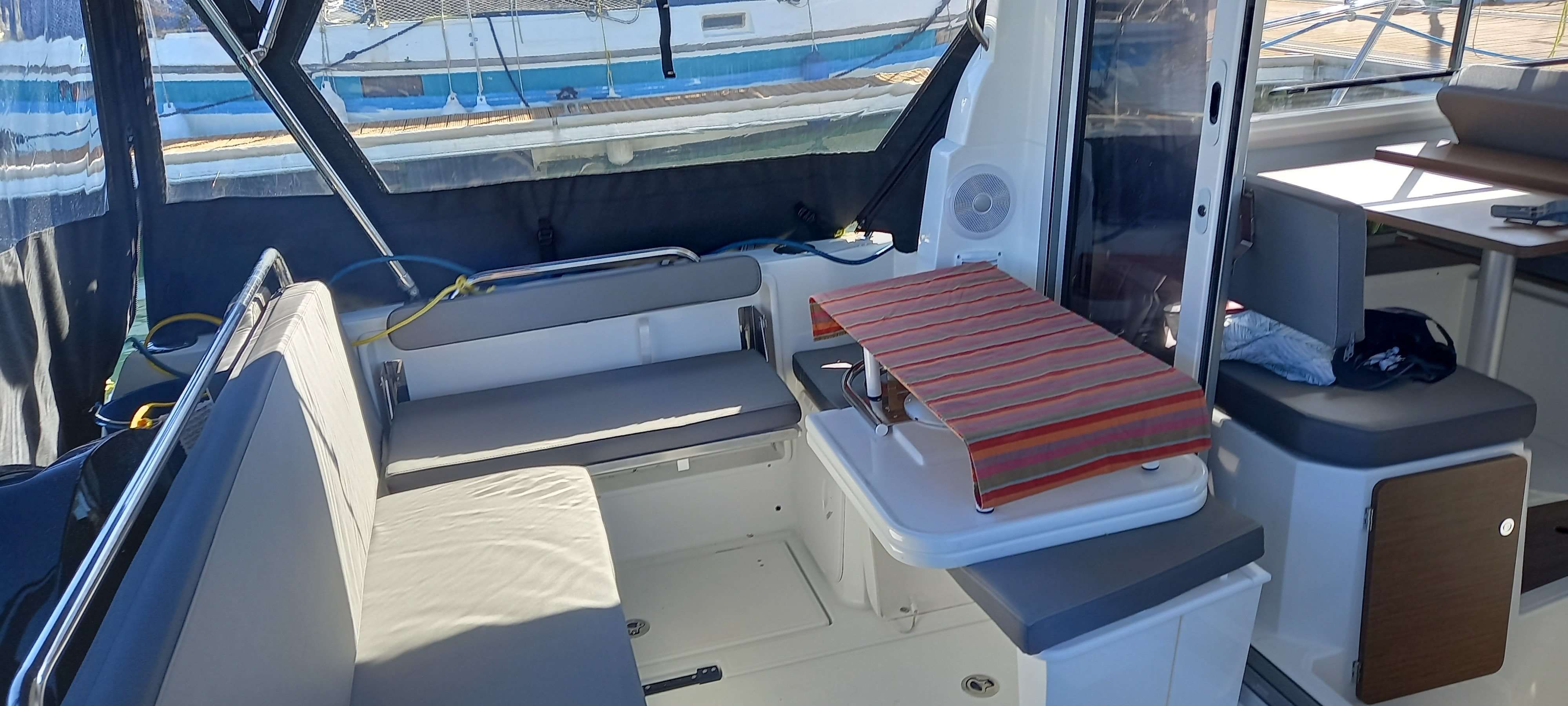 Beneteau Antares 8 V2 Interior of 2023 Beneteau Antares 8 V2 with seating and table.