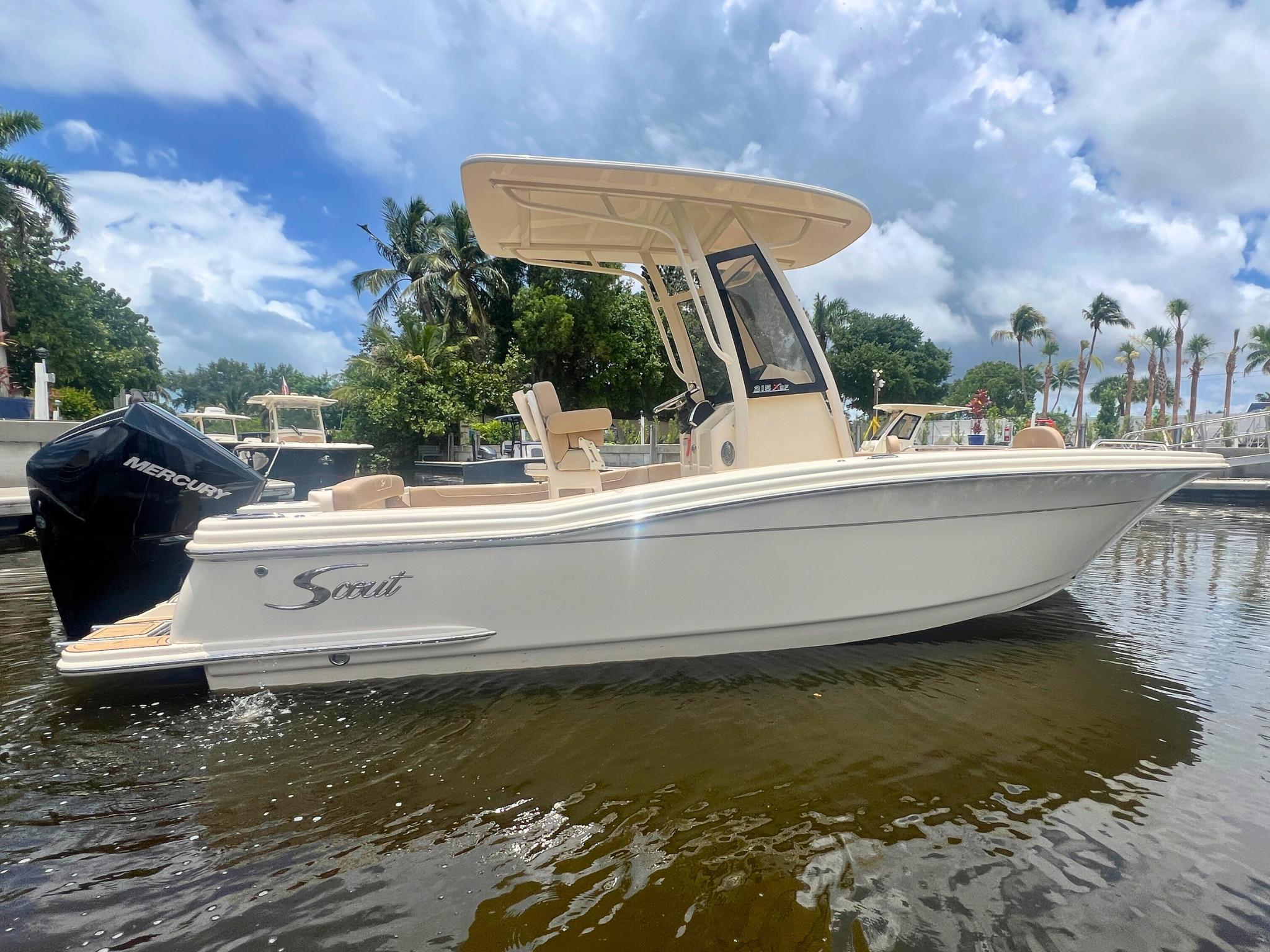 Scout 215 XSF 2025 Scout 215 XSF boat on water, featuring sleek design and Mercury engine.