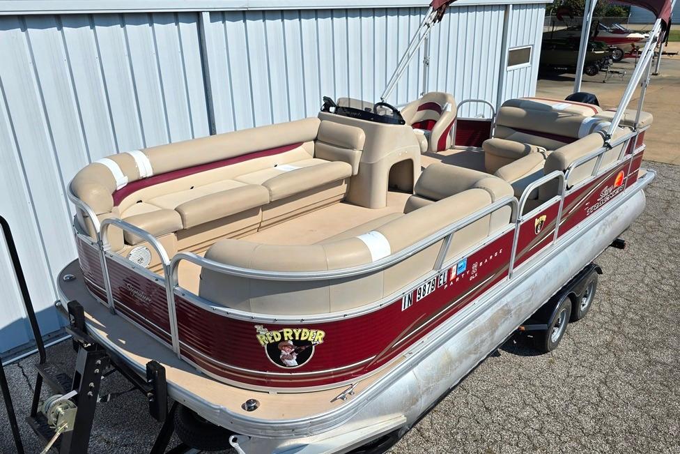 Sun Tracker 22 party barge deluxe 2012 Sun Tracker 22 Party Barge Deluxe pontoon boat with beige seating and red accents.