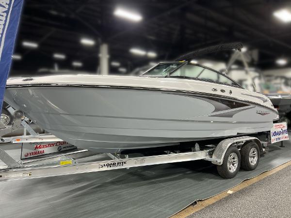 Monterey M-22 2025 Monterey M-22 boat on trailer in indoor showroom.