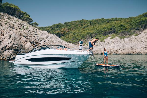 Beneteau Flyer 10 2024 Beneteau Flyer 10 in scenic coastal waters with people enjoying water activities.