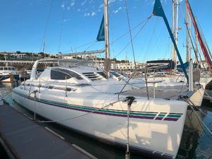 Admiral 38 2007 Admiral 38 yacht docked in marina, featuring sleek design and vibrant blue sails.