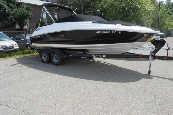 Sea Ray 220 Sundeck 2013 Sea Ray 220 Sundeck boat on trailer, parked outdoors.