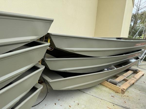 Tracker Grizzly 1436 Utility Stacked 2025 Tracker Grizzly 1436 Utility boats on a concrete surface.