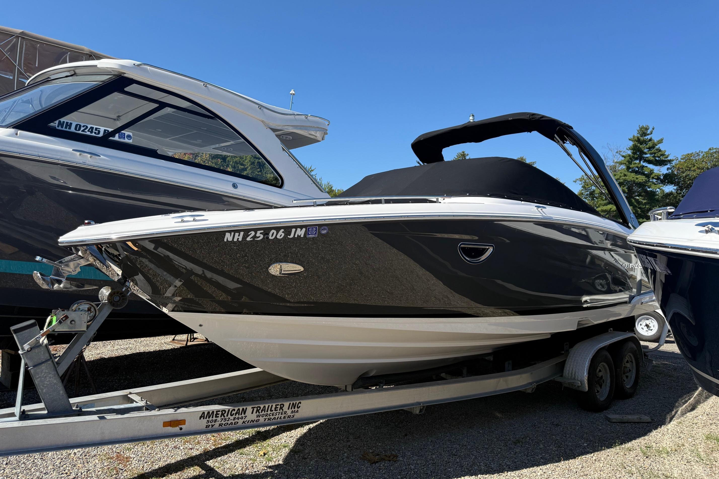 Regal 2800 Bowrider 2018 Regal 2800 Bowrider boat on trailer, black hull, parked outdoors.