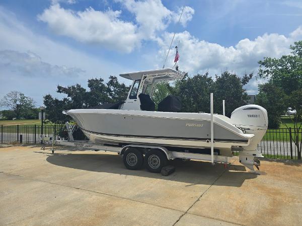 Pursuit S 248 Sport 2025 Pursuit S 248 Sport boat on trailer, parked outdoors under a partly cloudy sky.