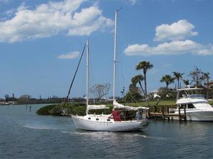 Custom Lazy Jack 32 1974 Custom Lazy Jack 32 sailboat cruising on a sunny day with palm trees in the background.