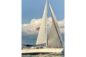 Catalina Morgan 440 DS Sailing yacht Catalina Morgan 440 DS 2005 on open water with American flag.