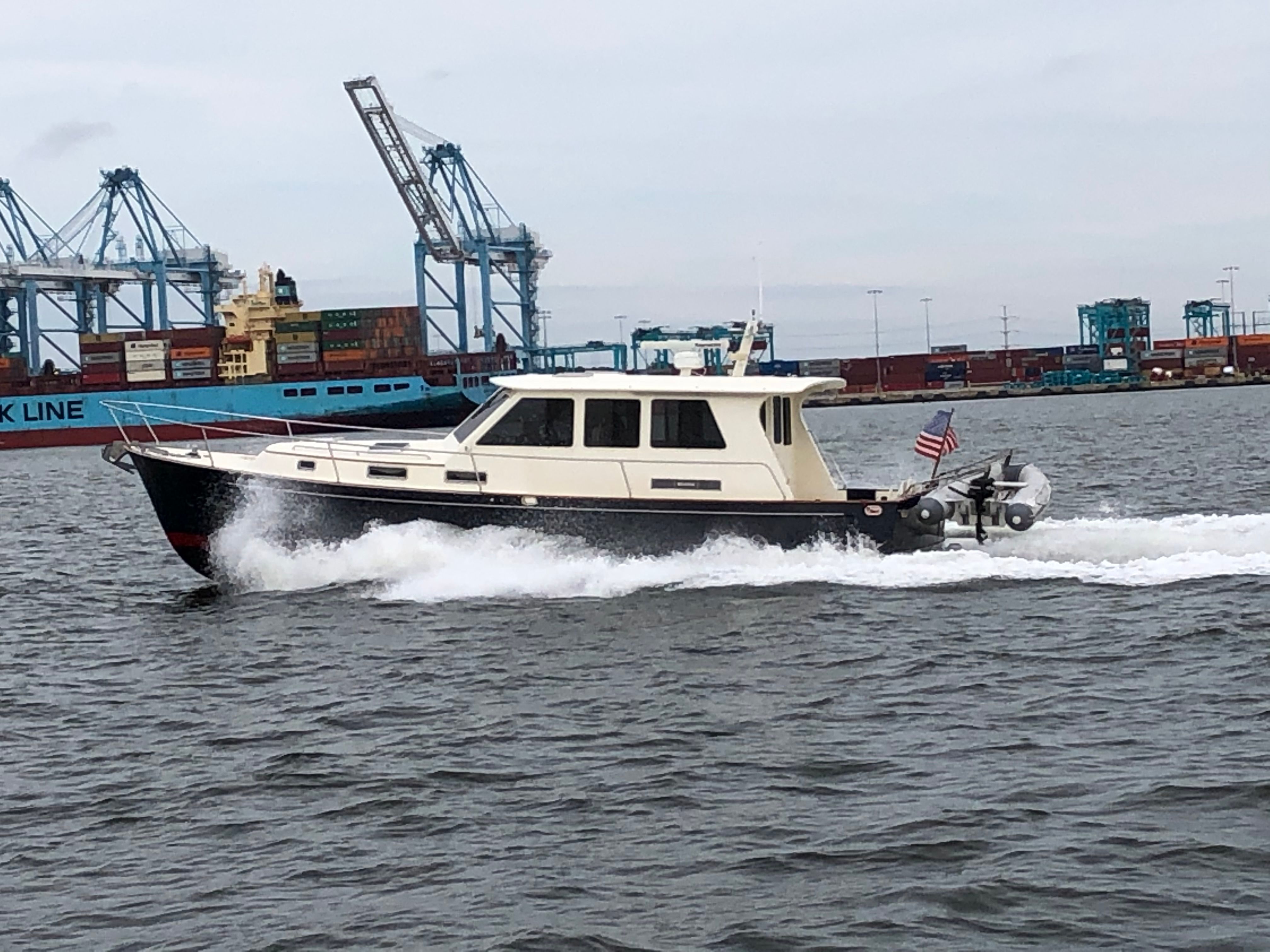 Legacy 42 Sedan Legacy 42 Sedan 2005 cruising in harbor near container ships.