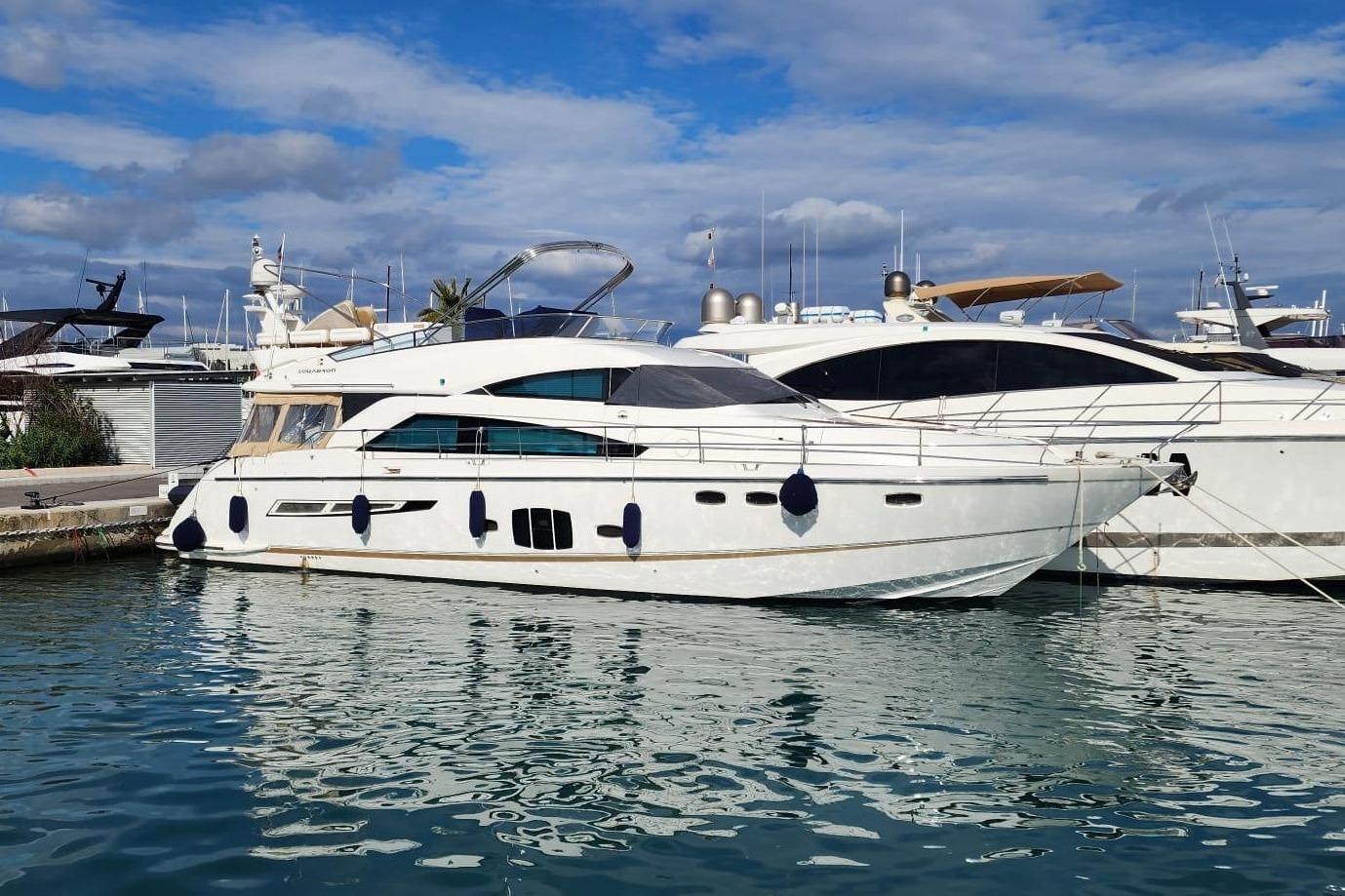 Fairline Squadron 55 2009 Fairline Squadron 55 yacht docked in a marina under a partly cloudy sky.