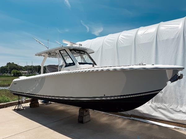 Pursuit S 328 Sport 2022 Pursuit S 328 Sport boat displayed outdoors on blocks.