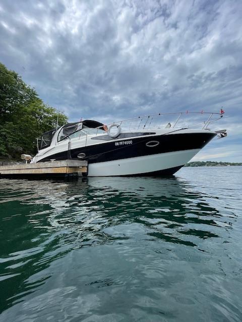 Bayliner SB340 2009 Bayliner SB340 yacht docked on a serene lake under a cloudy sky.