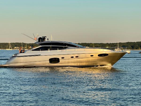 Pershing 62' Luxurious 2015 Pershing 62' yacht cruising on calm waters at sunset.