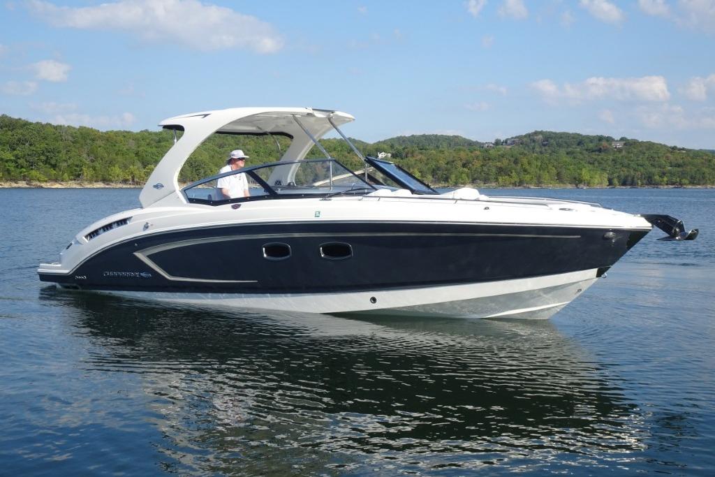 Chaparral 327 SSX 2015 Chaparral 327 SSX boat cruising on a scenic lake.