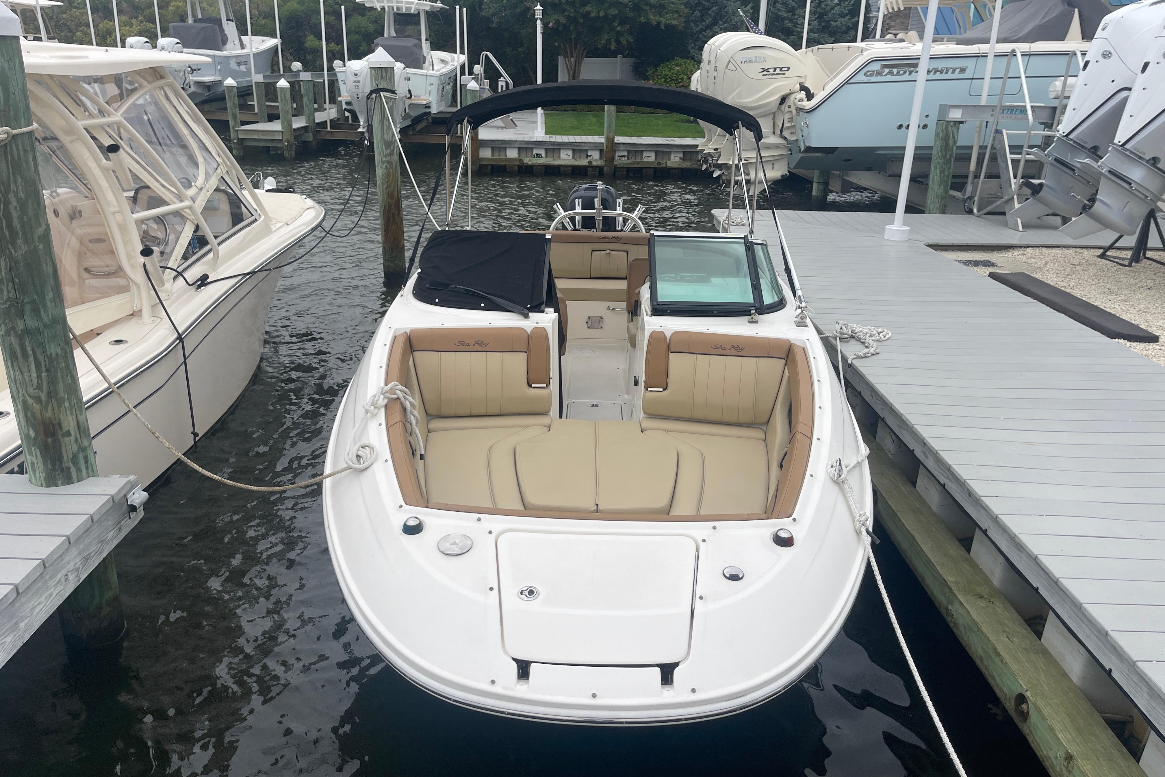Sea Ray 240 Sundeck Outboard 2014 Sea Ray 240 Sundeck Outboard docked, featuring spacious seating and sleek design.