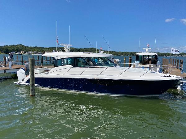 Tiara Yachts 43 LE 2025 Tiara Yachts 43 LE docked in a marina, blue hull, sunny day.