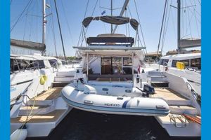 Nautitech 46 Fly 2018 Nautitech 46 Fly catamaran with dinghy, docked at marina.