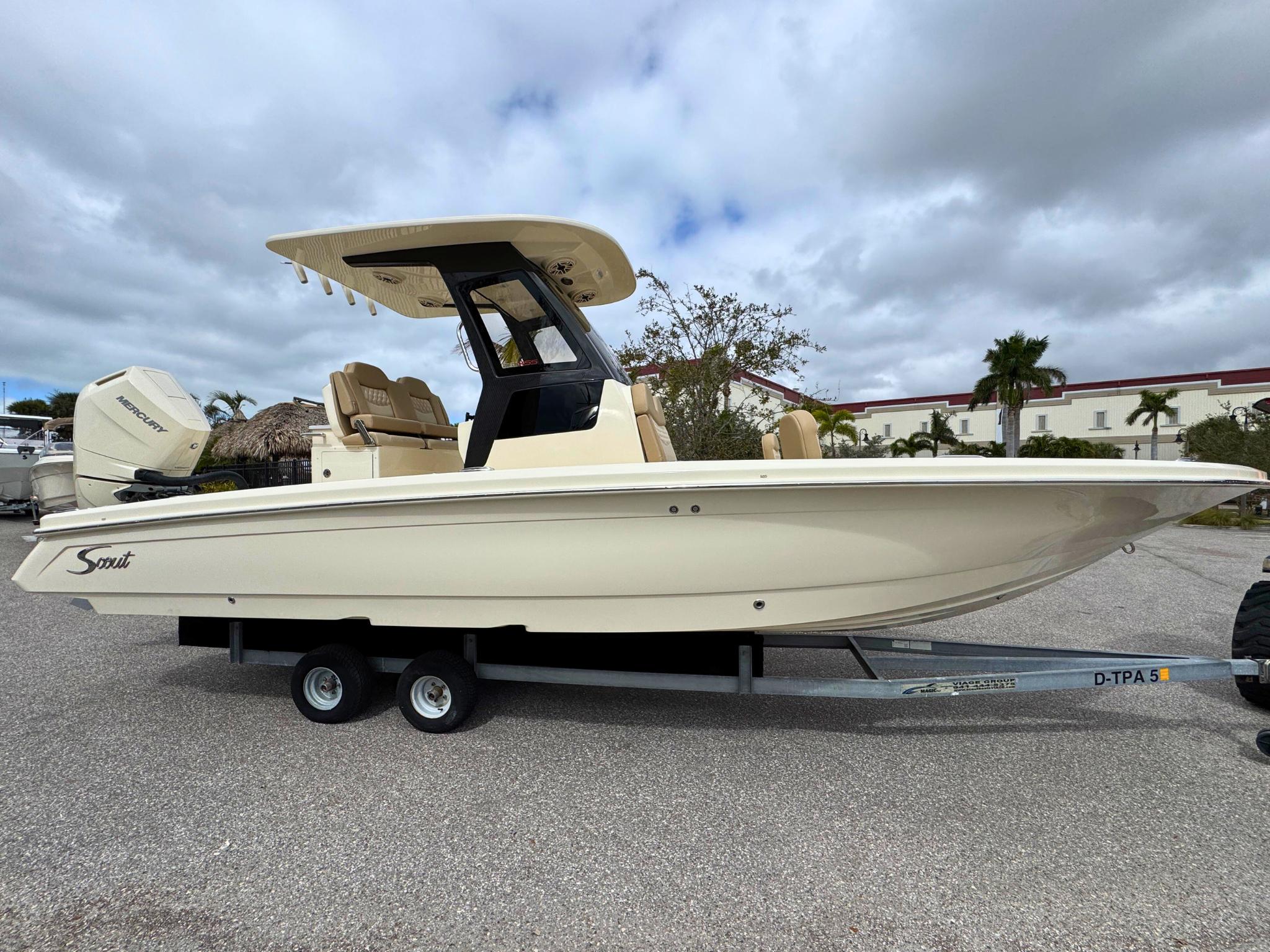 Scout 261 XSS 2025 Scout 261 XSS boat on trailer, side view, cloudy sky background.