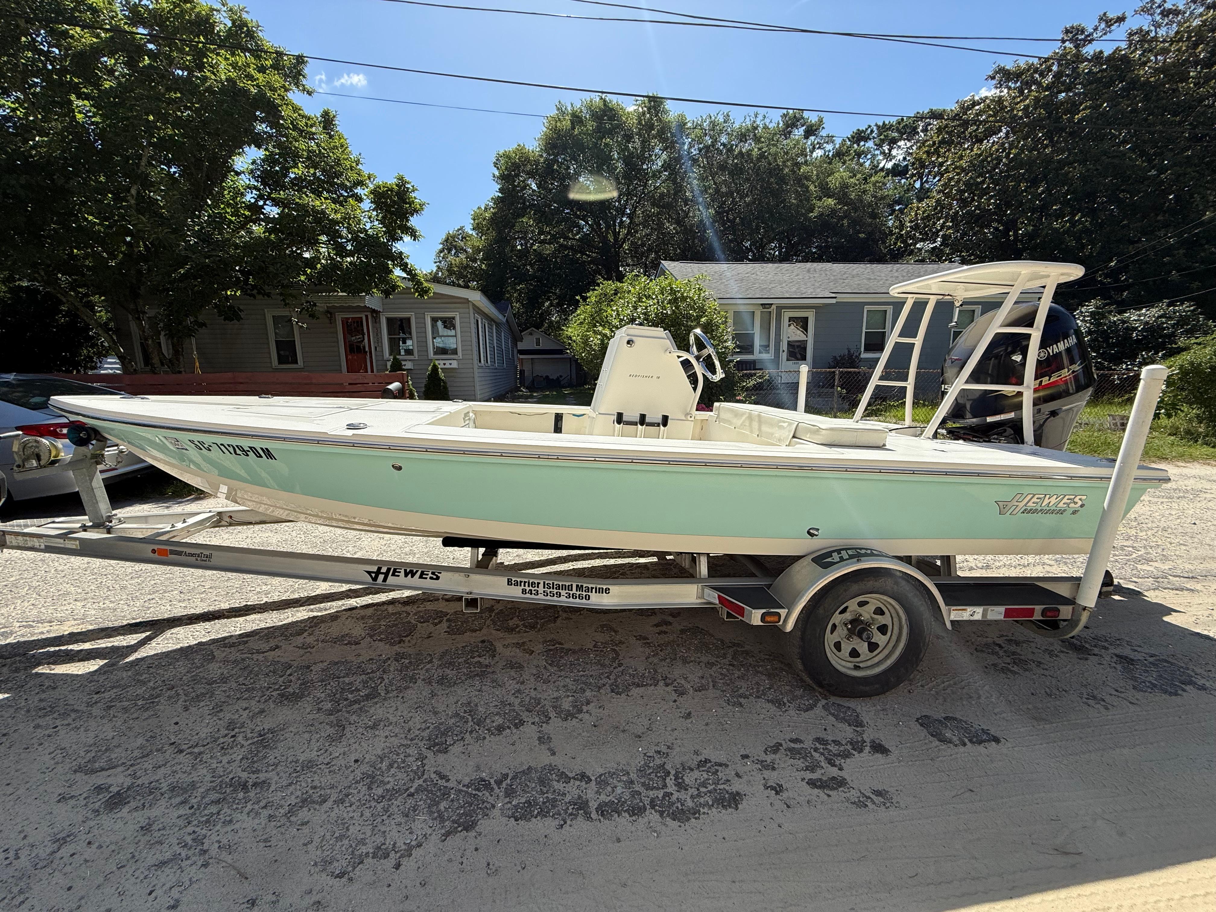 Hewes Redfisher 18 2015 Hewes Redfisher 18 boat on trailer, parked in residential area.