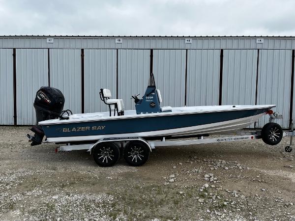 Blazer Bay 2220 Fisherman 2025 Blazer Bay 2220 Fisherman boat on trailer, parked in front of storage units.