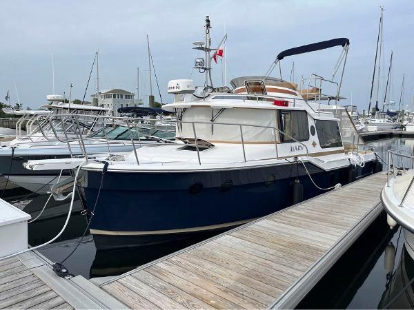 Ranger Tugs R-29 CB 2020 Ranger Tugs R-29 CB docked at marina, featuring sleek design and spacious deck.