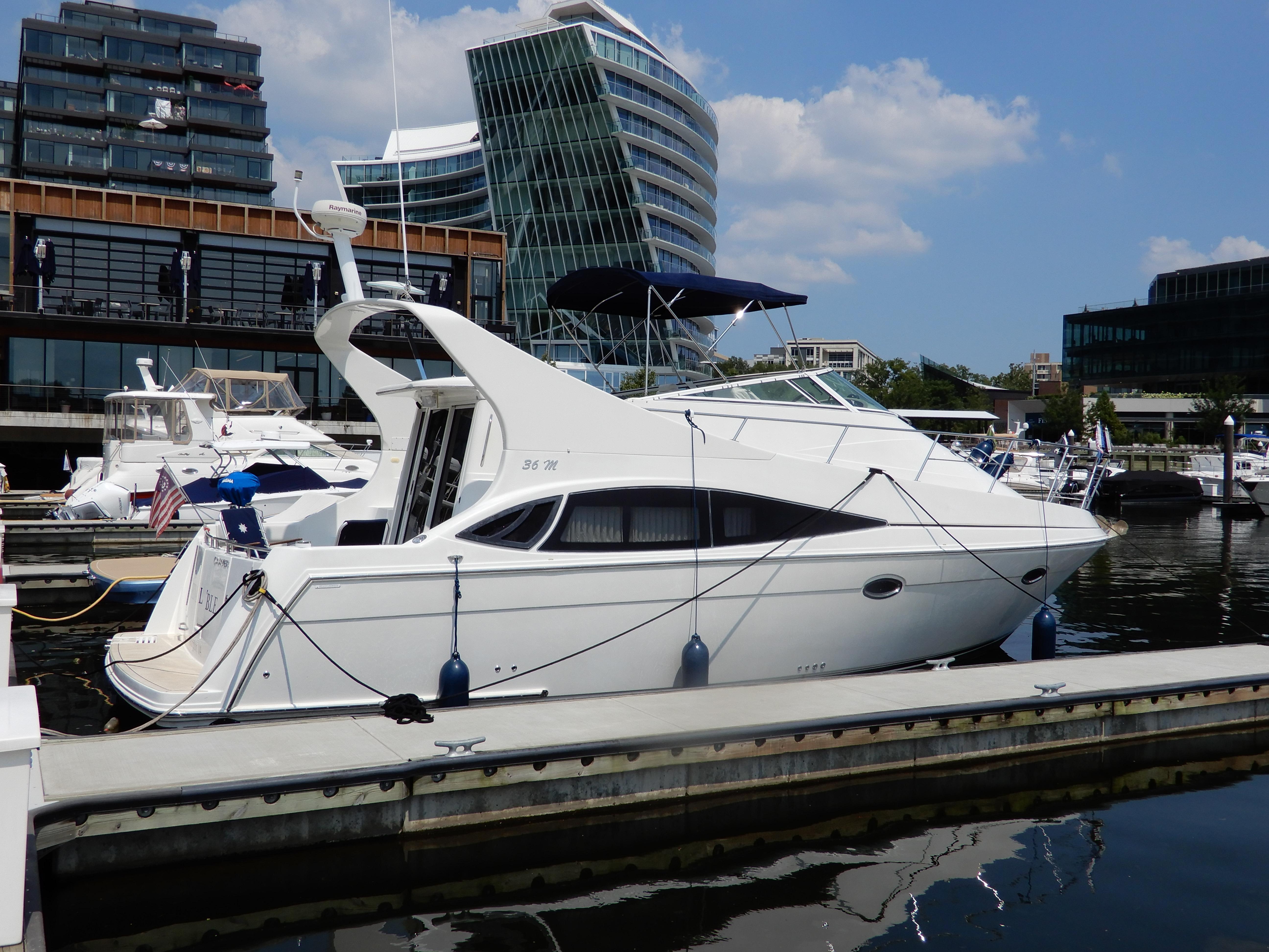 Carver 36 Mariner 2006 Carver 36 Mariner yacht docked at a marina with modern buildings in the background.