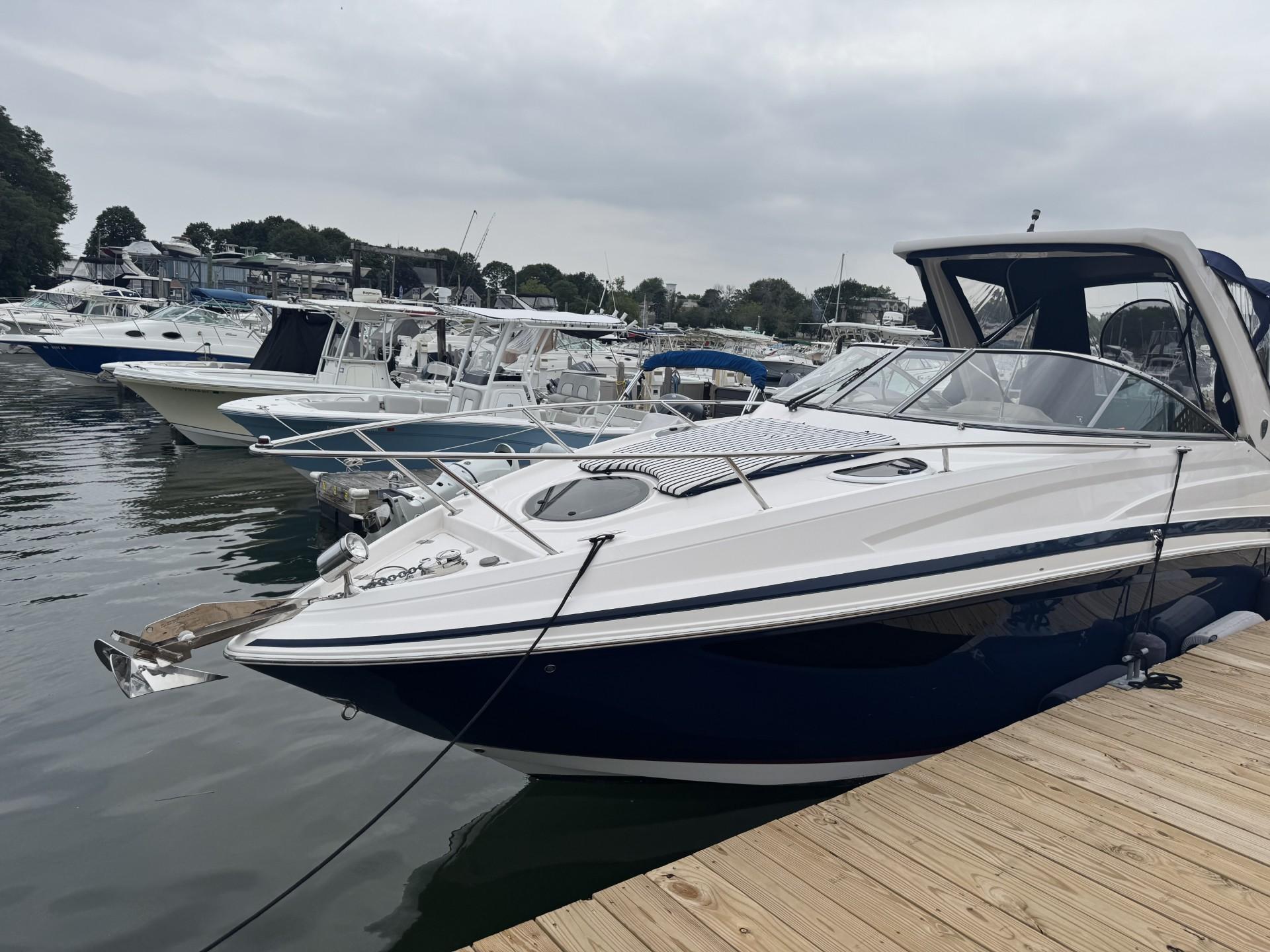 Regal 28 Express 2018 Regal 28 Express boat docked at marina, surrounded by other vessels.